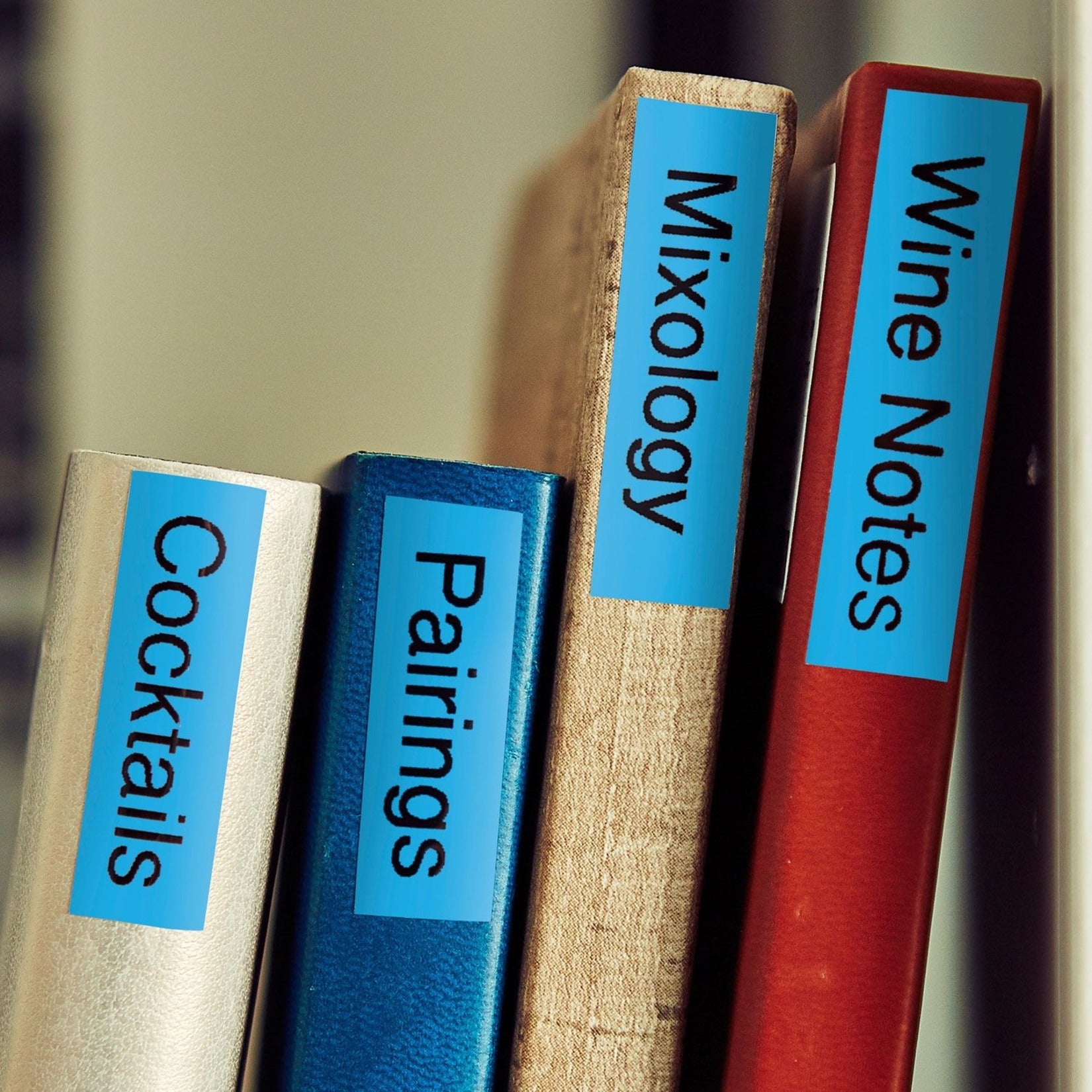 Book spines labeled with blue P-touch labels showing clear text organization-alternate-image4