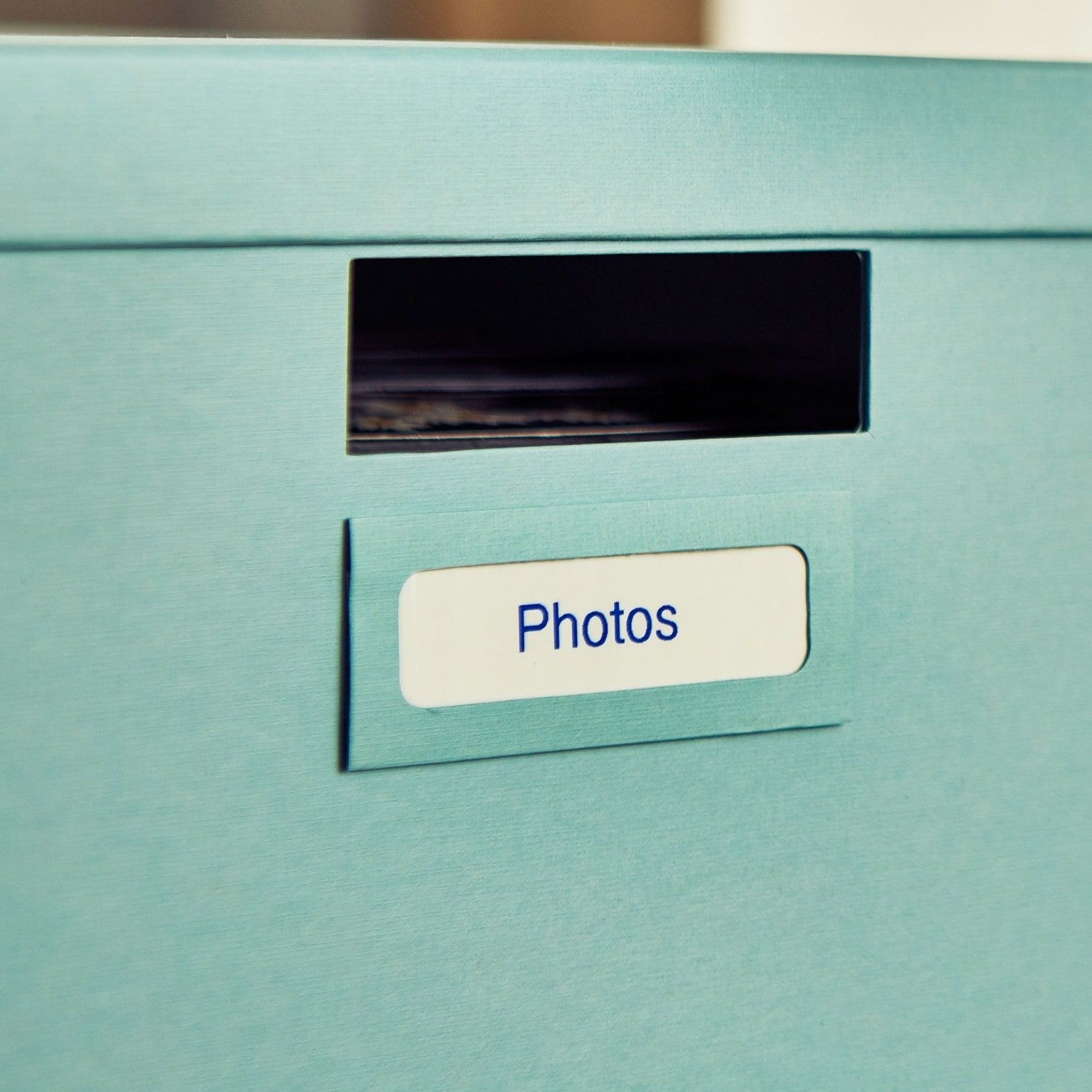 Close-up of blue-on-white Brother P-touch label applied to a photo storage box-alternate-image7